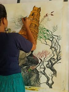 The delicate dance of brush and ink as a world takes shape